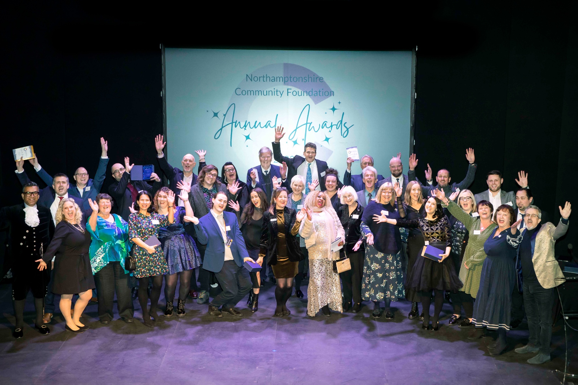 Award winners and judges on stage at the Royal Theatre, celebrating after the Annual Awards event